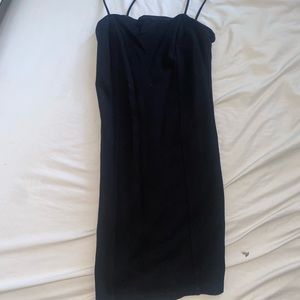 Black mini dress, hugs the skin